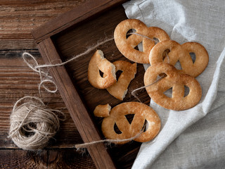 Sugar pretzels on a wooden tray.