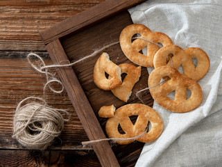 Sugar pretzels on a wooden tray.