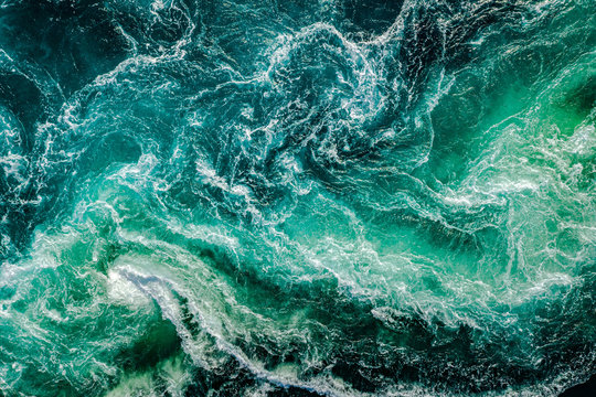 Waves of water of the river and the sea meet each other during high tide and low tide. © Andrey Armyagov