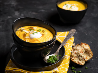 Pumpkin soup with sour cream, herbs and pumpkin seeds.