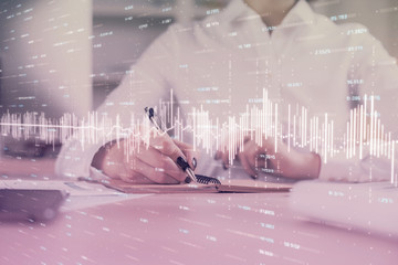 Financial chart drawn over hands taking notes background. Concept of research. Multi exposure