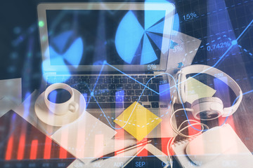 Financial market graph hologram and personal computer on background. Double exposure. Concept of forex.