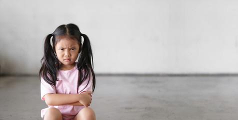 Asian child cute touchy or kid girl sitting face frown and angry aggressive with sad or have...