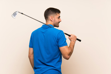 Young handsome golfer man over isolated background