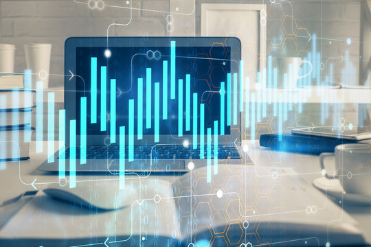 Forex market graph hologram and personal computer on background. Double exposure. Concept of investment. © peshkova