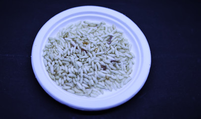 Saraswathi Pooja and Ayudha Pooja Celebrations - pori kadalai and onion in white bowl on black background.