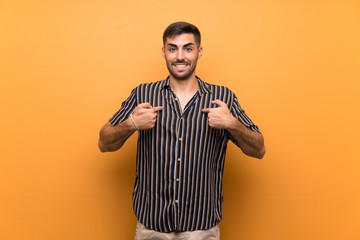 Handsome man with beard over isolated background with surprise facial expression