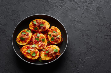 Golden Egg Curry in black bowl at dark slate background. Burmese Egg Curry is popular Myanmar Cuisine dish with duck or chicken eggs, tomatoes, ginger, onion, cilantro and spices.