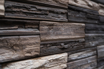 Natural stone bricks as a decoration on a wall. Natural stone wall texture. The walls are made of stones or marbles. Decoration for the walls or febces.