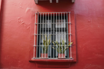 Window with colorful wall plan. Colorful architecture in Santa Marta, Colombia.