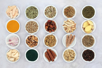 Asthma and respiratory relieving herbs, spice and supplement powders used in natural and chinese herbal medicine in porcelain bowls. Flat lay.