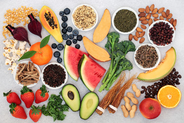 Super food for vitality, energy & fitness with fruit, vegetables, coffee, nuts and herbal medicine. Foods high in vitamins, minerals, antioxidants,smart carbs, protein & omega 3. Flat lay.