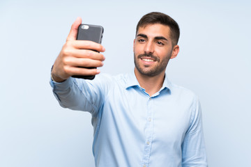Young handsome man with his mobile making a selfie