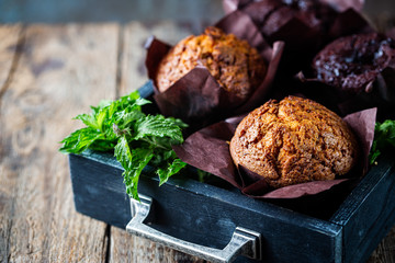 Homemade fresh baked carrot muffins with hazelnut and orange on wooden background
