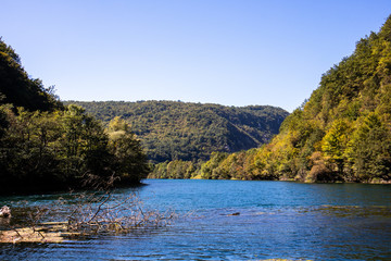 Beautiful and turquoise river Una in canyon on the Croatian and Bosnia and Herzegovina border. Forest and mountains next to the river.