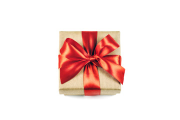 Festive gift box with red ribbon bow isolated on white background.