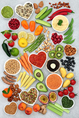 Vegan health food concept with nuts, seeds, fruit, vegetables, legumes, grains, spice& dips. Foods...
