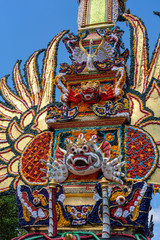 Bade cremation tower with traditional balinese sculptures of demons and flowers on central street in Ubud, Island Bali, Indonesia . Prepared for an upcoming cremation ceremony