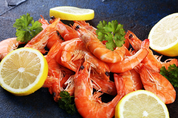 Raw fresh Prawns Langostino Austral. shrimp seafood with lemon and spices on dark