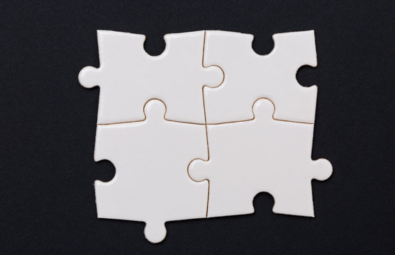 Four Puzzle pieces, on black background
