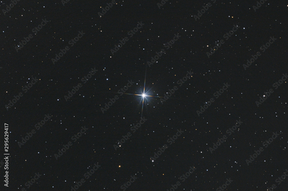 Wall mural closeup of the star sadr in cygnus constellation, with many stars as background in the deep space.