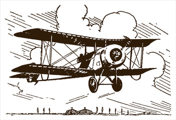Historical single-seat rotary-engined racing biplane flying over trees and hangars near an airfield © M