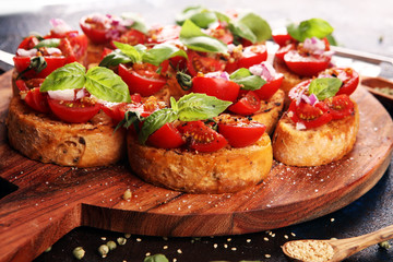 fresh tomato bruschetta. italian food appetizer with basil on table