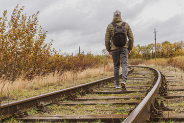 Man walking along railway