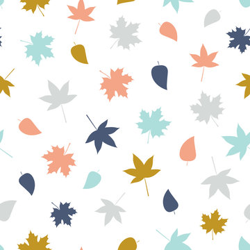 Vector seamless pattern of falling leaves in bright colours on a white background.