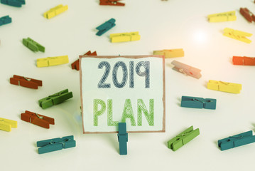 Word writing text 2019 Plan. Business photo showcasing setting up your goals and plans for the current year or in 2019 Colored clothespin papers empty reminder white floor background office