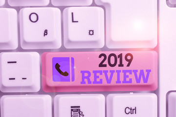 Conceptual hand writing showing 2019 Review. Concept meaning New trends and prospects in tourism or services for 2019 Keyboard with note paper on white background key copy space