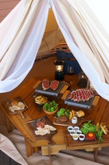 Meat dinner in outdoor tent