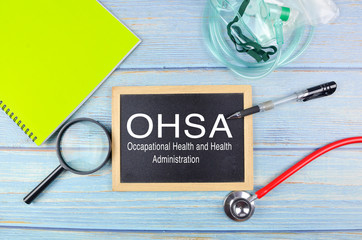 Osha, Occupational Safety and Health Administration. Blackboard on a wooden background.