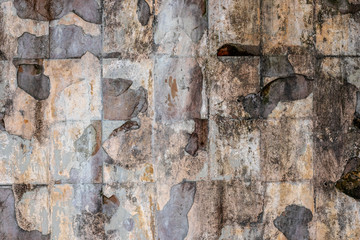 The old wall from which the tile crumbled in an abandoned Chernobyl house.
