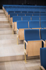 Empty blue seats in a conference room