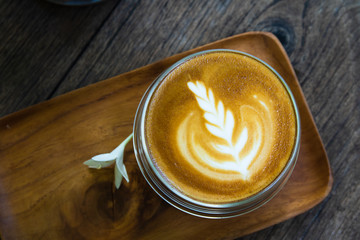 Latte coffee placed on a wooden table