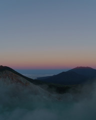 First light with fog. Sunrise on on the mountain  Ijen  Java ,Indonesia.