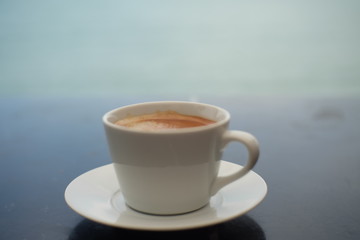 cup of coffee on wooden background