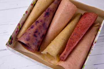 handmade homemade pastila in a box on a light background. A set of different fruits, fruit candy with apples, fruit candy with strawberries, fruit candy with currants