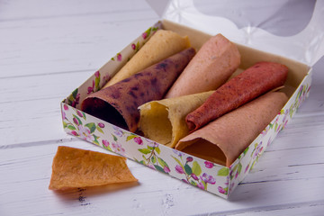 handmade homemade pastila in a box on a light background. A set of different fruits, fruit candy with apples, fruit candy with strawberries, fruit candy with currants