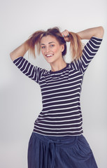 Naklejka premium Portrait of a beautiful young girl in a striped sweater