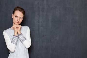 Portrait of pensive young woman waiting or listening somebody