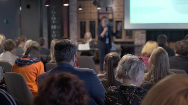 Audience listens lecturer at workshop