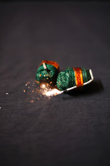 Diwali fire bomb cracker on black background