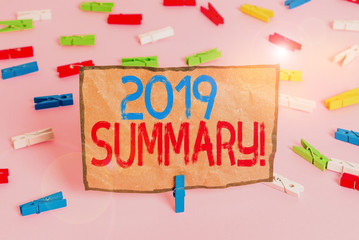 Handwriting text writing 2019 Summary. Conceptual photo summarizing past year events main actions or good shows Colored clothespin papers empty reminder pink floor background office pin