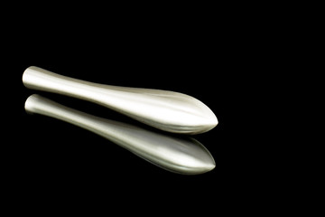shiny metal vibrator sex toys isolated on black background with reflection, female Dildo lying on black surface, orgasm object, Masturbation toys, black smooth stimulator made of quality material