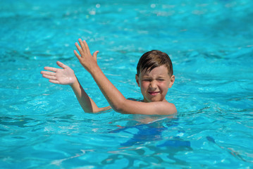 Active European boy doing morning gym in pool during his summer vacations in Spain. Entertainment program. - 295640003