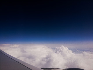 Fototapeta na wymiar airplane flying above the clouds