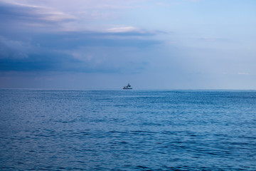 Calm morning Black Sea and boat on the horizon