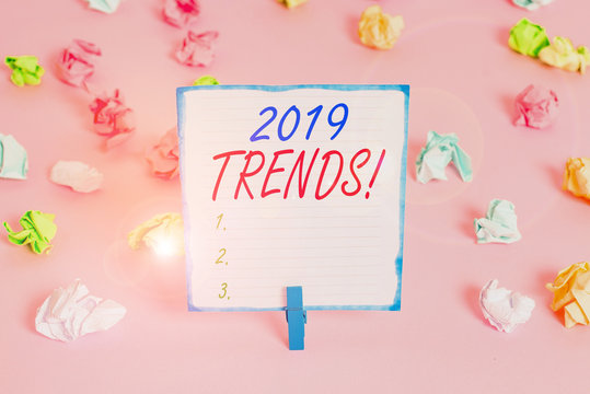 Handwriting text 2019 Trends. Conceptual photo general direction in which something is developing or changing Colored crumpled papers empty reminder pink floor background clothespin